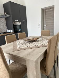 a dining room table with chairs and a wooden table with a plate on it at La Corte del Moro in Pachino +15 photos