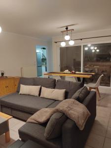 a living room with a couch and a table at Rania's house in Aigio