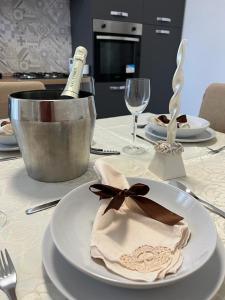 a white plate with a bottle of wine on a table at La Corte del Moro in Pachino
