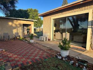 a backyard with a brick patio and a house at Garden View Home in Brakpan