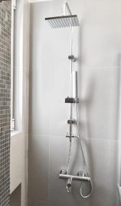 a shower with a shower head in a bathroom at Grand Panoramic Villa II Lagonissi in Lagonissi