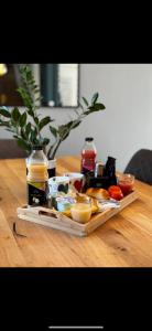 a wooden table with a tray of food on it at LES TEMPS HEUREUX exclusivement Familles in Quimper