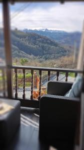 a balcony with chairs and a view of a mountain at La Casina de Asturias in Mieres