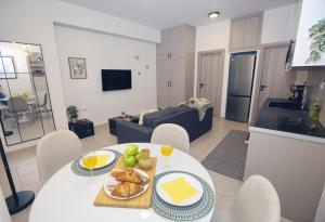 a living room with a table with a plate of food at EVNEA in Nafplio