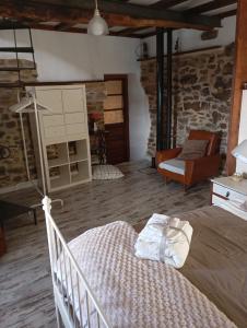 a bedroom with a bed and a couch in a room at La Casina de Asturias in Mieres