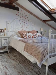 a bedroom with a white bed and a window at La Casina de Asturias in Mieres