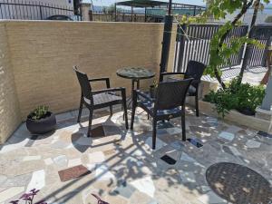 four chairs and a table on a patio at Sea Star Danica apartments in Tivat