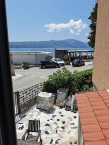 a balcony with two chairs and a view of a parking lot at Sea Star Danica apartments in Tivat