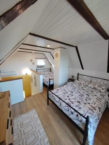 a bedroom with two beds in a attic at Holiday home Sunce i Zora in Jalžabet