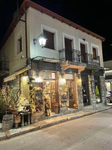 a store on the side of a street at night at Agora Mansion in Arachova +9 photos