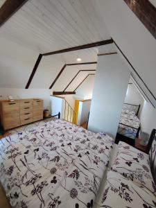 a bedroom with a large bed in a attic at Holiday home Sunce i Zora in Jalžabet