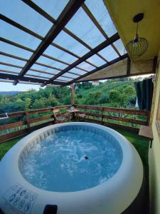 a hot tub on a patio with a roof at Holiday home Sunce i Zora in Jalžabet
