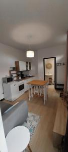 a living room with a table and a kitchen at Studio indépendant in Laval