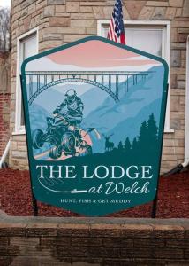 a sign for the lodge atolkien in front of a building at The Lodge at Welch in Welch