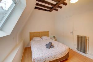 a bedroom with a bed with a book on it at Cœur de Ville - T3 - 6 personnes - Arrivée Autonome in Tours