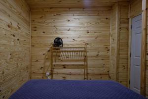 a bedroom with a bed in a wooden wall at The Lodge at Welch in Welch