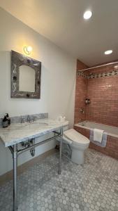 a bathroom with a sink and a toilet and a tub at The Parador in Santa Fe