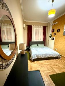 a bedroom with a large bed and a mirror at Cozy home in Nea Smirni in Athens