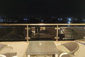 un balcón con mesa y sillas en un barco en Comfortable softness en El Cairo