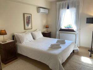 a bedroom with a bed with two towels on it at House with View in Amfithea in Ioannina