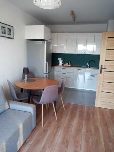 sala de estar con mesa y cocina en Apartament Lux Corner Park Warsaw, en Pruszków