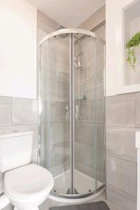 a bathroom with a toilet and a glass shower at Stylish & modern studio in Burnley in Burnley