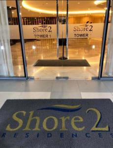 a store sign in front of a store window at Condotel-Shore 2 Residences MOA in Manila