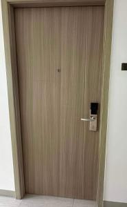 a wooden door with a handle in a room at Condotel-Shore 2 Residences MOA in Manila