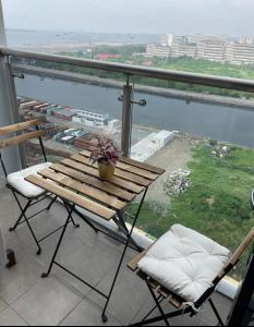 a table and chairs on a balcony with a view at Condotel-Shore 2 Residences MOA in Manila
