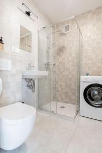 a bathroom with a shower and a toilet and a sink at Apartament na Powiślu in Warsaw