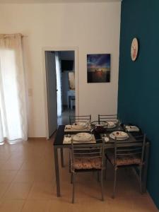 a dining room with a table and two chairs at Vitali sea house I in Vitálion