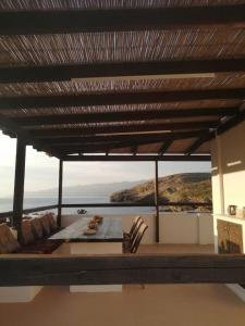 a room with a table and a view of the ocean at Vitali sea house I in Vitálion