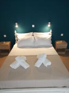 a bed with two white towels on top of it at Vitali sea house I in Vitálion