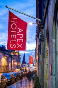 a street with flags on the side of a building at Apex Waterloo Place Hotel in Edinburgh
