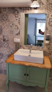 a bathroom with a sink and a mirror at Dom Šumiac - prízemie in Šumiac