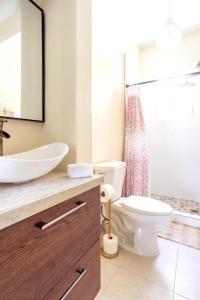 a bathroom with a white toilet and a sink at 610@Miramar in San Juan