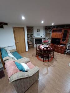 a living room with a couch and a table at Casa dos Avós in Avelal +4 photos