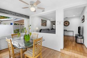 a dining room and living room with a glass table and chairs at Perfect FLL Location with Putting Green in Fort Lauderdale