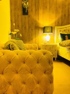 a bedroom with a bed and a table with a lamp at Viceroy Royal Hotel Apartment Islamabad in Islamabad