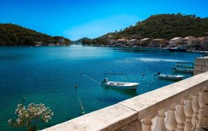 a river with two boats in the water and houses at Charming Holiday Home Lady Kate in Lastovo