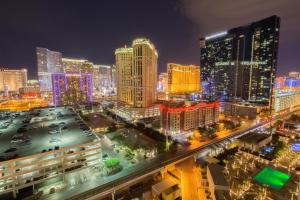 a view of a city at night at No Resort Fee Strip View Balcony+ Free Valet+ Pool in Las Vegas