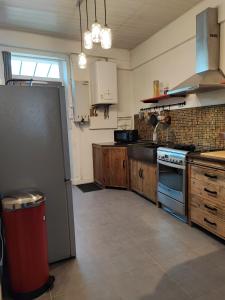 a kitchen with a refrigerator and a stove at Aux portes de Lyon in Saint-Fons