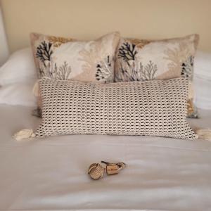 a close up of a bed with two pillows at Hôtel La Marine in Barneville-Carteret