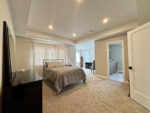 a bedroom with a bed and a desk and a television at Brand new modern home in Breslau in Maryhill