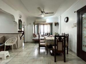 a living room with a dining room table and chairs at Calm Private Room with Beautiful View in Mumbai