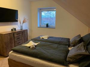 a bedroom with a bed with two towels on it at Home - Ostružina in Olomouc