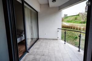 a room with a balcony with a view of a field at AH Herberia in Košice