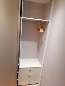 a white walk in closet with white shelves at Apartament Gagarina 31 in Zabrze