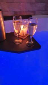 two wine glasses and candles on a table at Villa Malvasio Retreat & Spa in Sassari