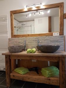 a bathroom with two sinks and a mirror at Chalet Steinplatte in Reit im Winkl
